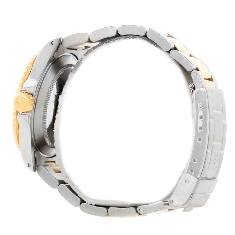 The image shows a side view of a Rolex Submariner 16613 Men's Steel and Gold (two tone) Champagne Dial 16613 Men's Steel and Gold (two tone) Champagne Dial watch, focusing on the bracelet and the crown.