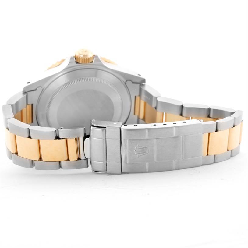 This image shows the backside of a Rolex Submariner 16613 Men
s Steel and Gold (two tone) Black Dial 16613 Men
s Steel and Gold (two tone) Black Dial watch, focusing on the stainless steel and gold bracelet with a clasp.