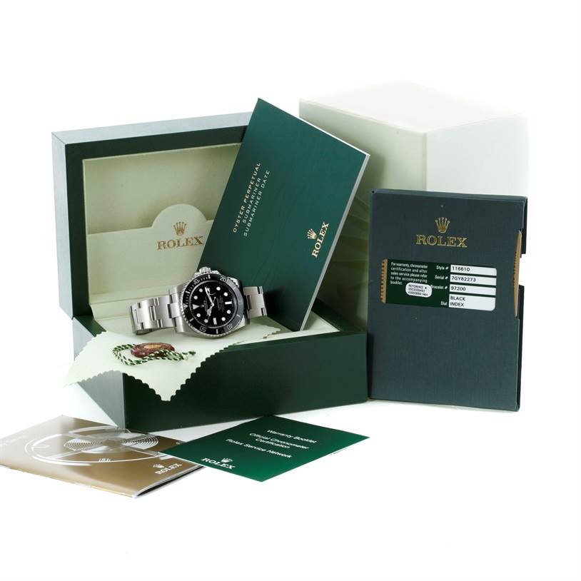 The Rolex Submariner 116610 Men
s Stainless Steel Black Dial 116610 Men
s Stainless Steel Black Dial watch is shown in its open box with accompanying booklets and tags displayed.