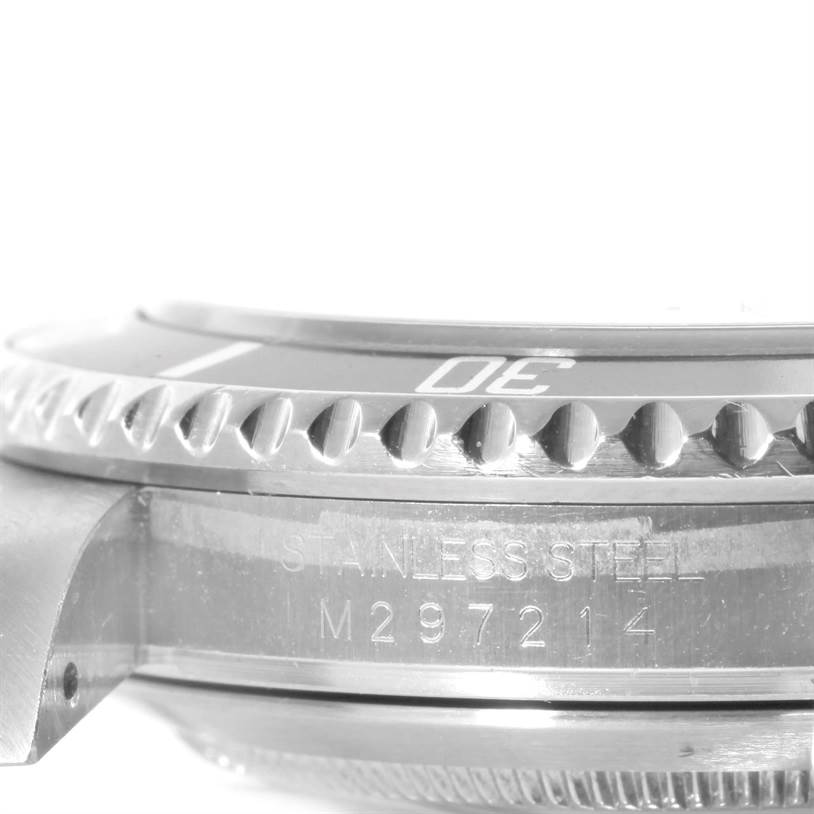 The image shows a close-up of the side profile of a Rolex Submariner 16610 Men
s Stainless Steel Black Dial 16610 Men
s Stainless Steel Black Dial watch, highlighting the bezel, engravings, and part of the case.