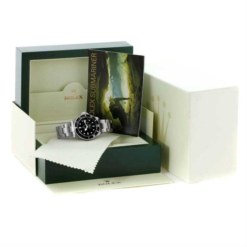 The Rolex Submariner 16610 Men
s Stainless Steel Black Dial 16610 Men
s Stainless Steel Black Dial watch is shown in its box with a booklet and a polishing cloth.