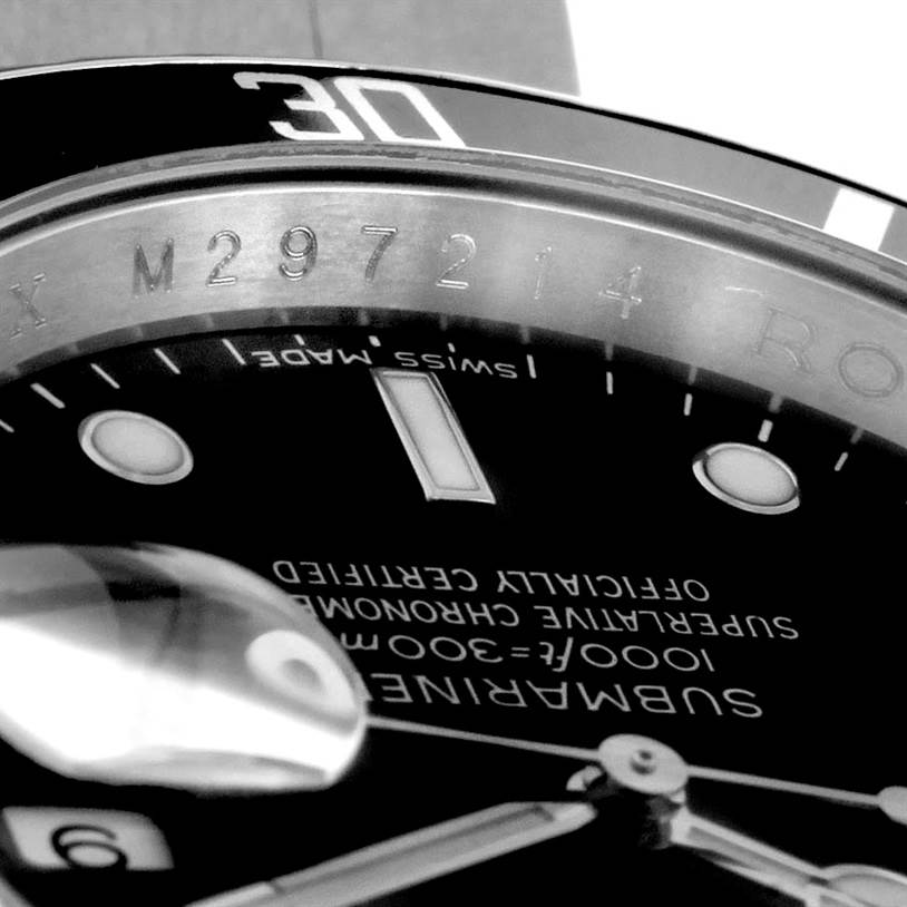 The image shows a close-up of the dial and bezel of a Rolex Submariner 16610 Men
s Stainless Steel Black Dial 16610 Men
s Stainless Steel Black Dial watch, including the bezel
s 30 mark and part of the serial number.