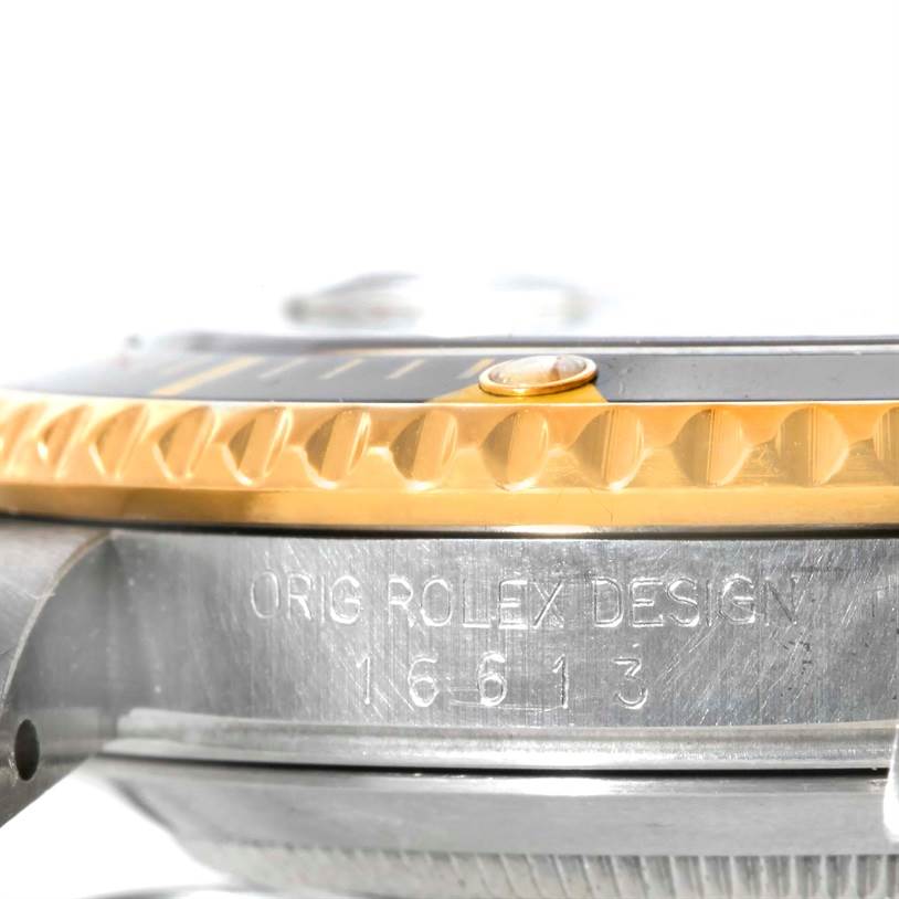 This image shows a close-up side view of the bezel and case of the Rolex Submariner 16613 Men's Steel and Gold (two tone) Black Dial 16613 Men's Steel and Gold (two tone) Black Dial model 16613.