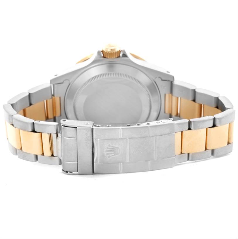 This image shows the back of a Rolex Submariner 16613 Men's Steel and Gold (two tone) Black Dial 16613 Men's Steel and Gold (two tone) Black Dial watch, highlighting its two-tone bracelet and clasp.