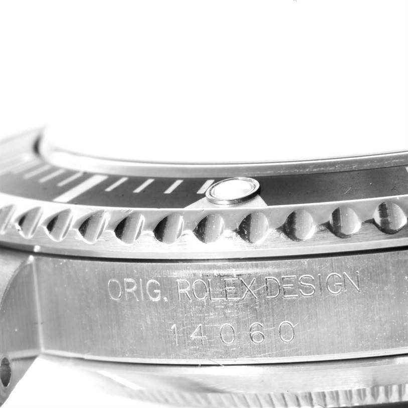 The image shows a close-up side view of a Rolex Submariner 14060 Men
s Stainless Steel Black Dial 14060 Men
s Stainless Steel Black Dial watch, focusing on the bezel and engraved model number 14060.