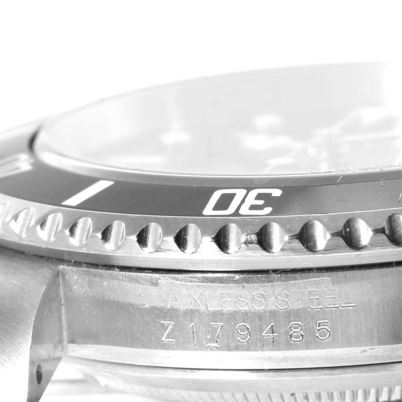 This image shows a close-up of the bezel and engraved serial number on the side of a Rolex Submariner 16610 Men
s Stainless Steel Black Dial 16610 Men
s Stainless Steel Black Dial watch.