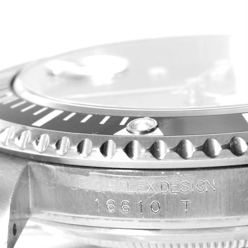 This close-up image shows the bezel, part of the dial, and the engraved model number on a Rolex Submariner 16610 Men
s Stainless Steel Black Dial 16610 Men
s Stainless Steel Black Dial.