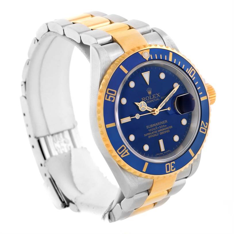 This image shows a Rolex Submariner 16613 Men's Steel and Gold (two tone) Blue Dial 16613 Men's Steel and Gold (two tone) Blue Dial watch at a three-quarter angle, highlighting the blue dial, bezel, and two-tone metal bracelet.