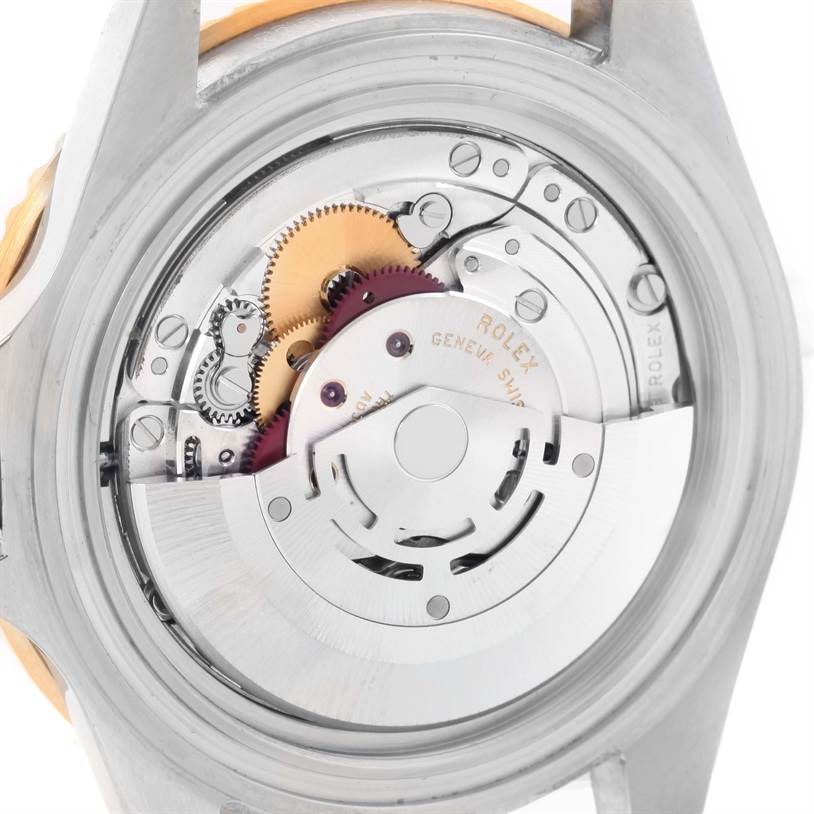 This image shows the back view of a Rolex Submariner 16613 Men's Steel and Gold (two tone) Blue Dial 16613 Men's Steel and Gold (two tone) Blue Dial watch, highlighting the intricate internal movement and gears.