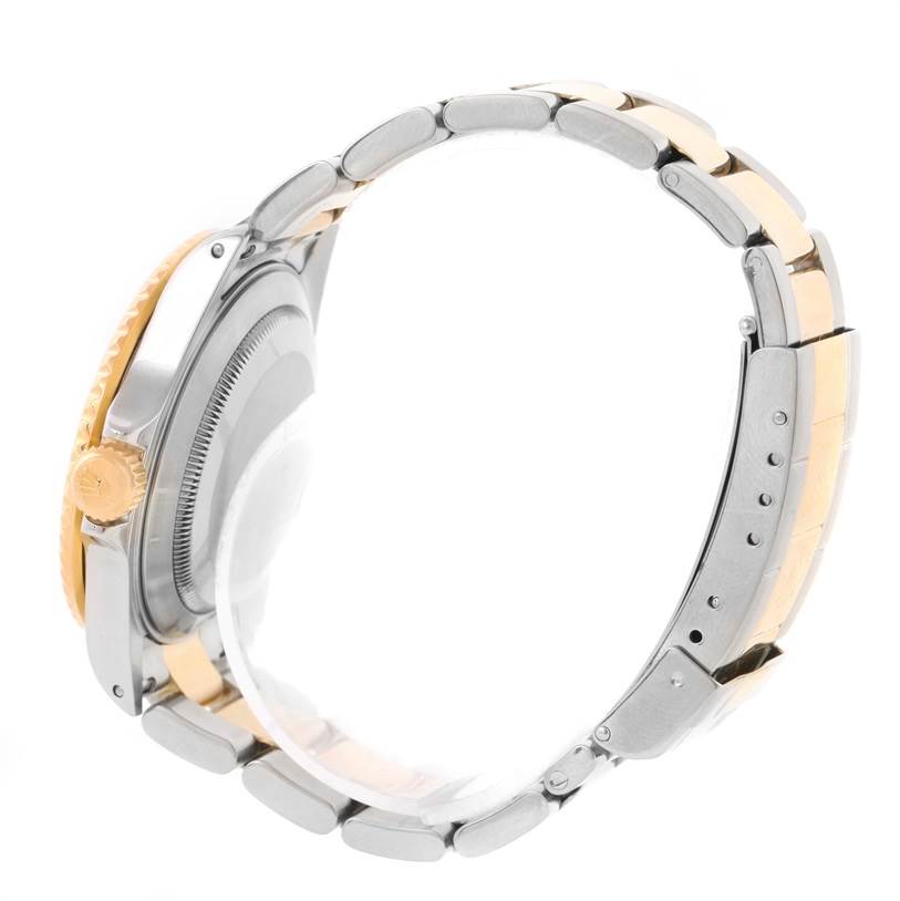 The image shows a side view of the Rolex Submariner 16613 Men's Steel and Gold (two tone) Blue Dial 16613 Men's Steel and Gold (two tone) Blue Dial watch, highlighting its crown, bezel, and two-tone metal bracelet.