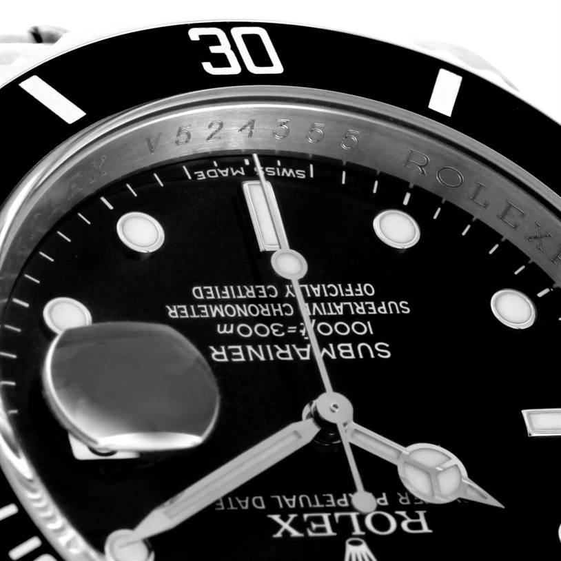 This close-up image of the Rolex Submariner 16610 Men
s Stainless Steel Black Dial 16610 Men
s Stainless Steel Black Dial watch shows the bezel, part of the dial, hands, and magnified date window.