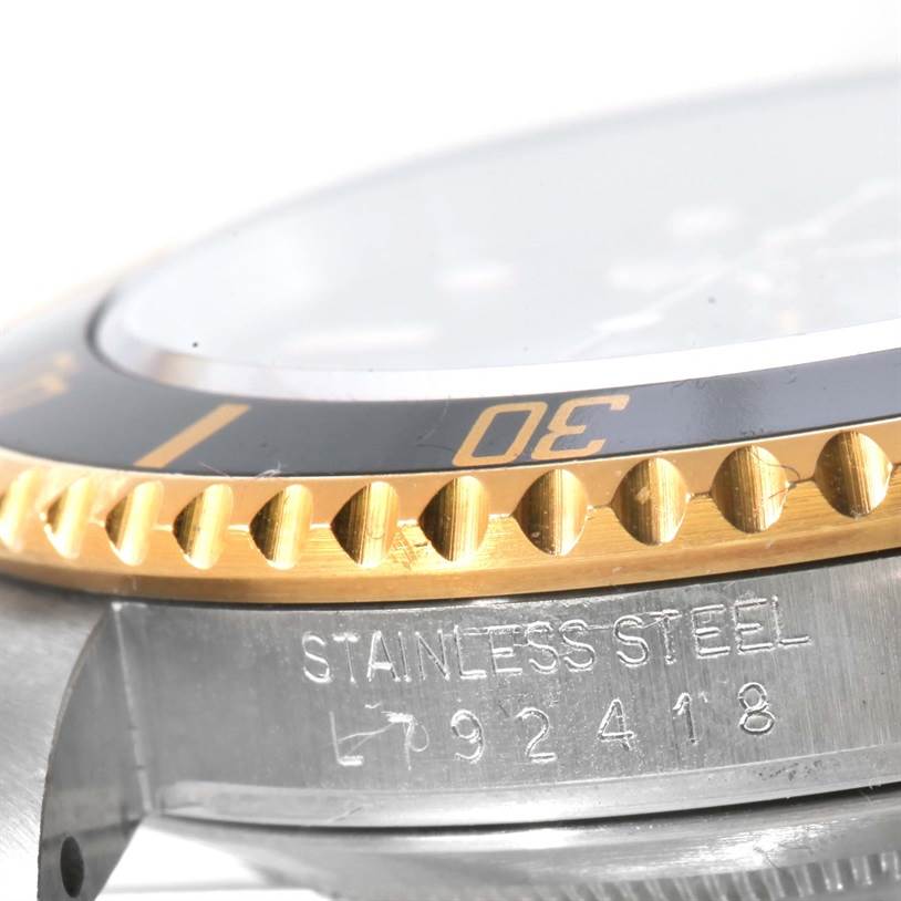This close-up angle shows the bezel and a portion of the stainless steel case of a Rolex Submariner 16613 Men's Steel and Gold (two tone) Black Dial 16613 Men's Steel and Gold (two tone) Black Dial watch.