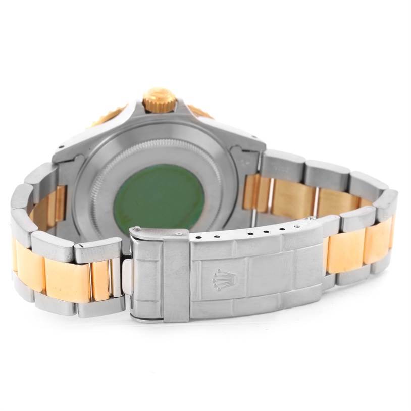 This image shows the backside and clasp of a Rolex Submariner 16613 Men's Steel and Gold (two tone) Black Dial 16613 Men's Steel and Gold (two tone) Black Dial watch, highlighting its two-tone bracelet and case back.