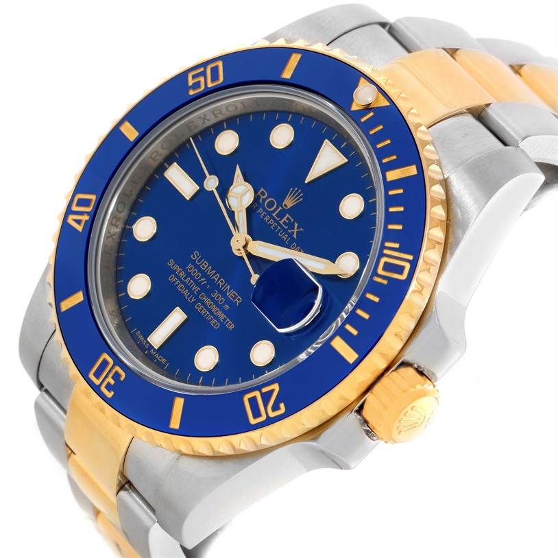 The image shows a Rolex Submariner 116613 Men's Steel and Gold (two tone) Blue Dial 116613 Men's Steel and Gold (two tone) Blue Dial watch from an angled close-up, highlighting the blue dial, blue and gold bezel, and two-tone bracelet.