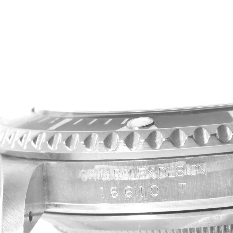 This close-up angle shows the side view of the Rolex Submariner 16610 Men
s Stainless Steel Black Dial 16610 Men
s Stainless Steel Black Dial bezel and part of the case with reference number 16610.