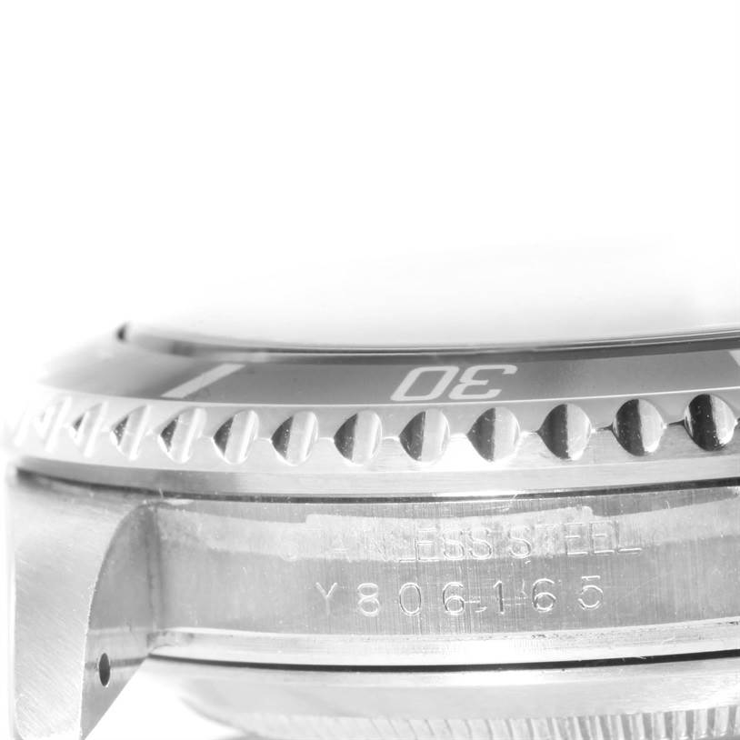 This image shows a close-up side view of the bezel and case, focusing on the serial number and material of the Rolex Submariner 16610 Men
s Stainless Steel Black Dial 16610 Men
s Stainless Steel Black Dial.