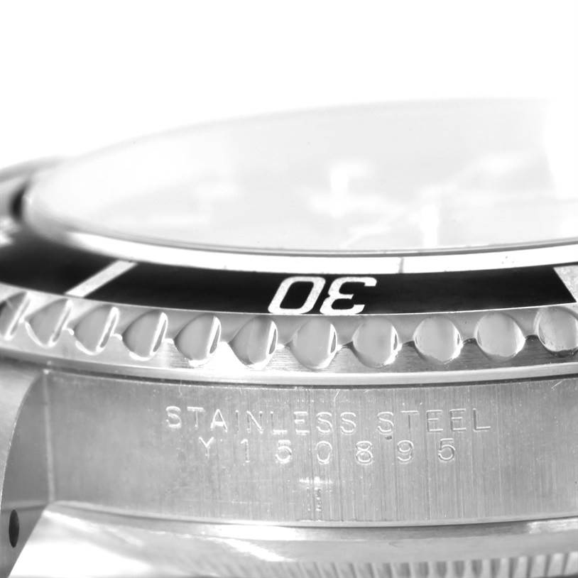 This image shows a close-up side view of a Rolex Submariner 14060 Men
s Stainless Steel Black Dial 14060 Men
s Stainless Steel Black Dial, highlighting the bezel and "STAINLESS STEEL" engraving.