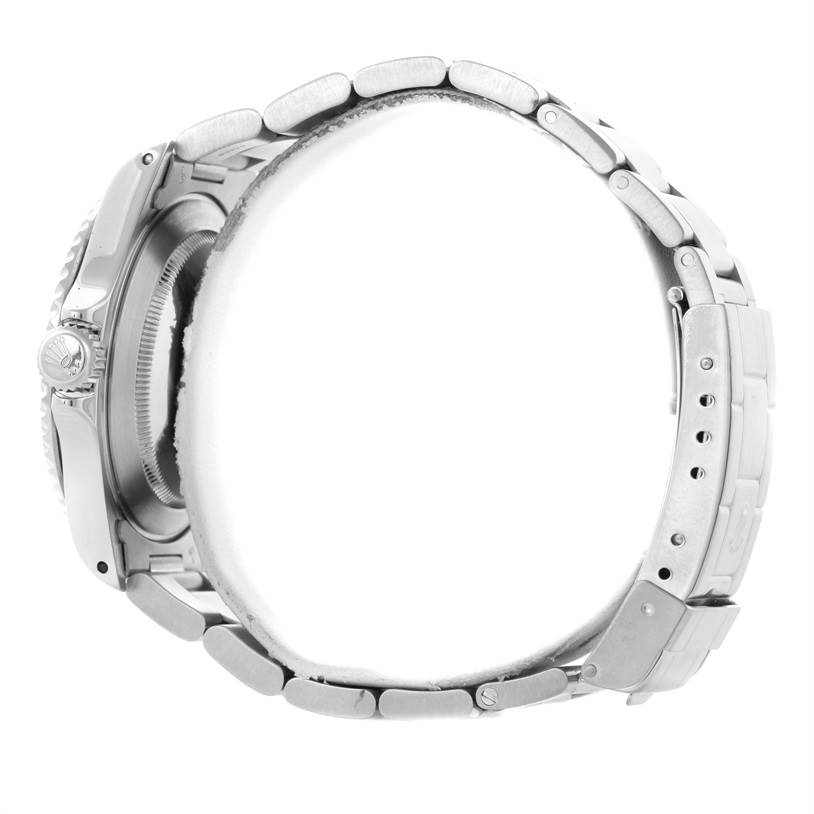 This image shows a side view of a Rolex Submariner 14060 Men
s Stainless Steel Black Dial 14060 Men
s Stainless Steel Black Dial watch focusing on its stainless steel case, crown, and bracelet with clasp.