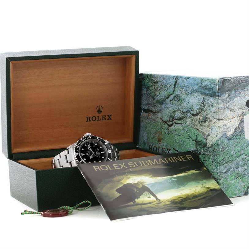 The image shows a Rolex Submariner 16610 Men's Stainless Steel Black Dial 16610 Men's Stainless Steel Black Dial watch in an open Rolex box with accompanying booklet and accessories.