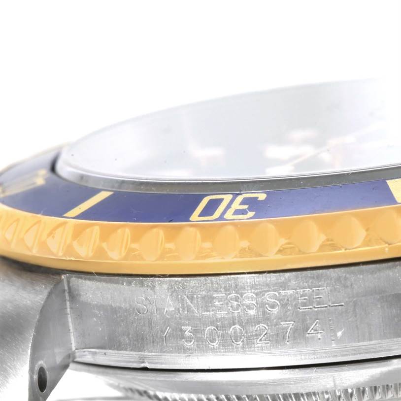 This close-up angle shows the side of the bezel and part of the case of the Rolex Submariner 16613 Men's Steel and Gold (two tone) Blue Dial 16613 Men's Steel and Gold (two tone) Blue Dial watch.