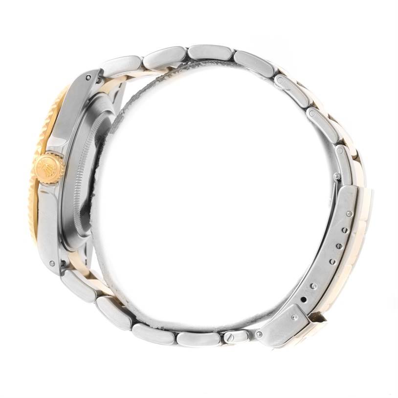 The image shows a side view of a Rolex Submariner 16613 Men's Steel and Gold (two tone) Blue Dial 16613 Men's Steel and Gold (two tone) Blue Dial watch, highlighting its crown and bracelet.