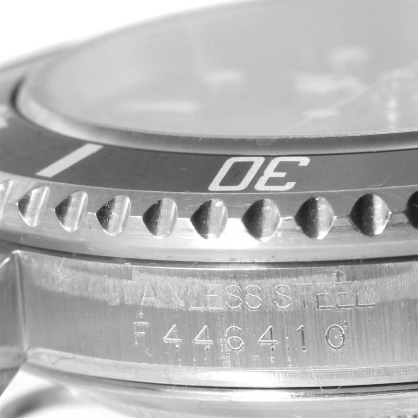 The image displays a close-up view of the bezel and the case side of a Rolex Submariner 16610 Men
s Stainless Steel Black Dial 16610 Men
s Stainless Steel Black Dial watch, highlighting the "30" mark and serial number.