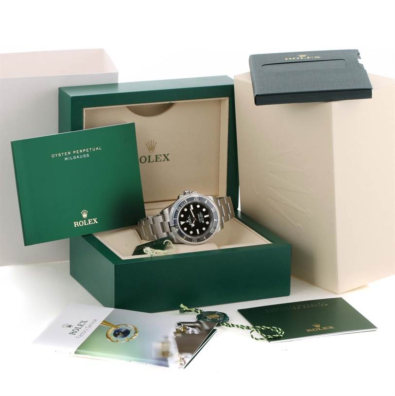 The image shows a Rolex Submariner 114060 Men
s Stainless Steel Black Dial 114060 Men
s Stainless Steel Black Dial watch in its box, accompanied by manuals and accessories from a front angle.