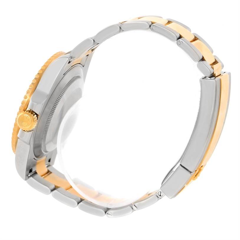 This image shows a Rolex Submariner 116613 Men's Steel and Gold (two tone) Blue Dial 116613 Men's Steel and Gold (two tone) Blue Dial watch from a side angle, highlighting its two-tone bracelet and gold crown.