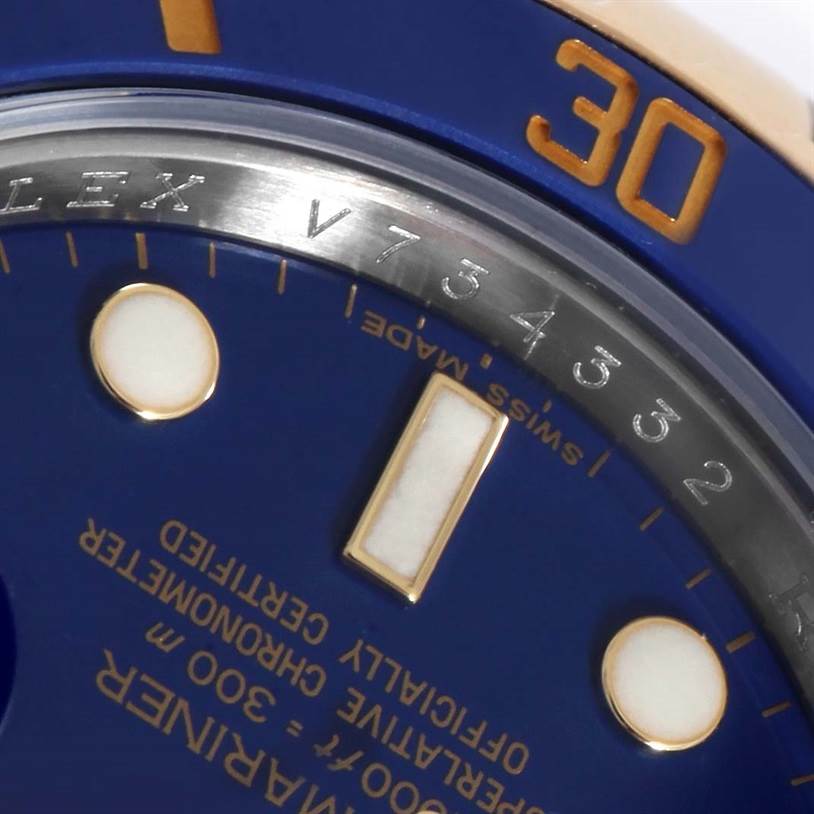 The image shows a close-up of the bezel, dial, and markers of a Rolex Submariner 116613 Men's Steel and Gold (two tone) Blue Dial 116613 Men's Steel and Gold (two tone) Blue Dial watch, highlighting its detailed engravings.