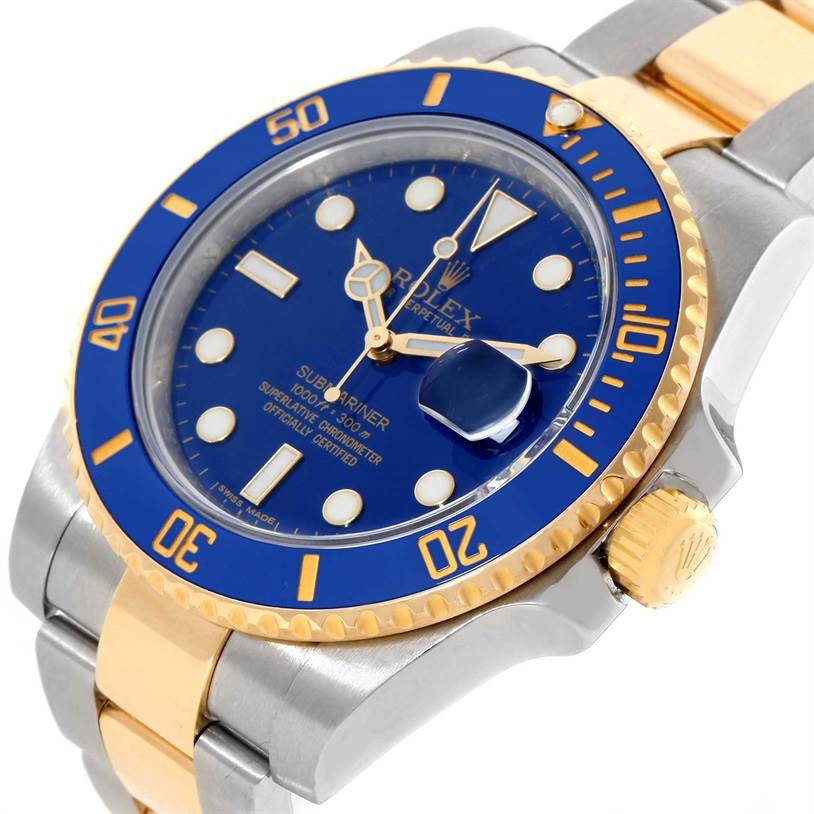This image shows a close-up angle of a Rolex Submariner 116613 Men's Steel and Gold (two tone) Blue Dial 116613 Men's Steel and Gold (two tone) Blue Dial watch featuring its blue dial, gold bezel, and part of its metal and gold bracelet.