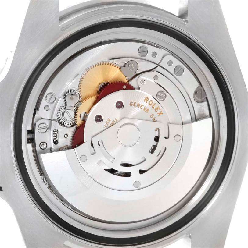 This image shows a close-up of the movement mechanism inside a Rolex Submariner 116610LV Men's Stainless Steel Green Dial 116610LV Men's Stainless Steel Green Dial watch, showcasing gears and intricate parts.