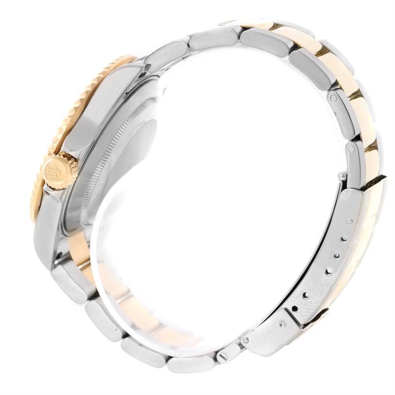 The image shows the side profile of a Rolex Submariner 16613 Men's Steel and Gold (two tone) Blue Dial 16613 Men's Steel and Gold (two tone) Blue Dial watch, including the crown, case, and metal bracelet.