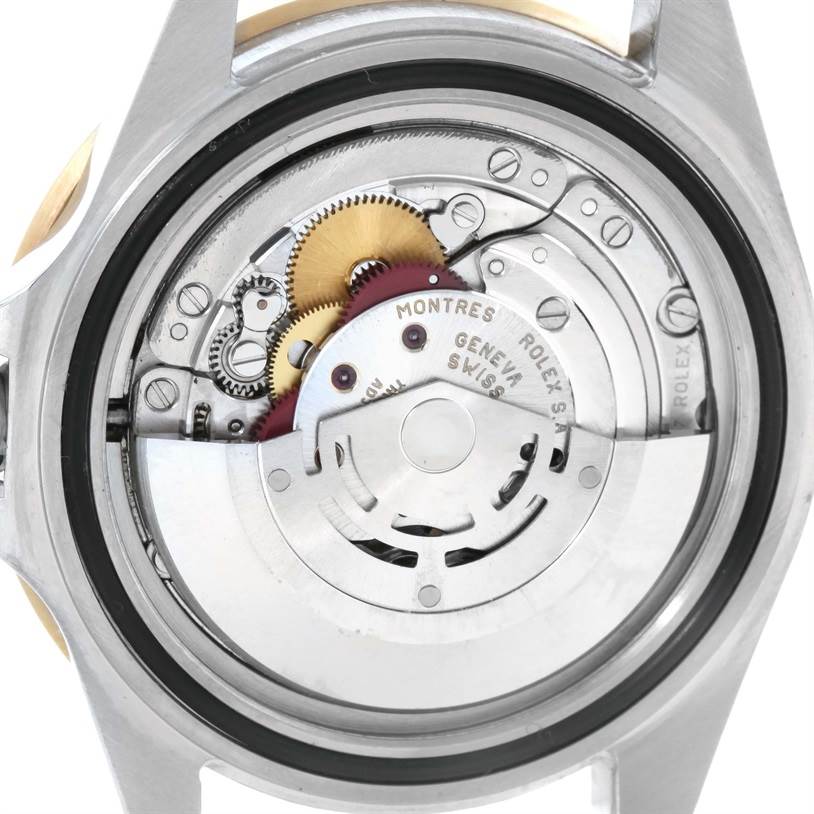 The image shows the back view of a Rolex Submariner 16613 Men's Steel and Gold (two tone) Blue Dial 16613 Men's Steel and Gold (two tone) Blue Dial watch, clearly revealing its intricate inner mechanical movement components.