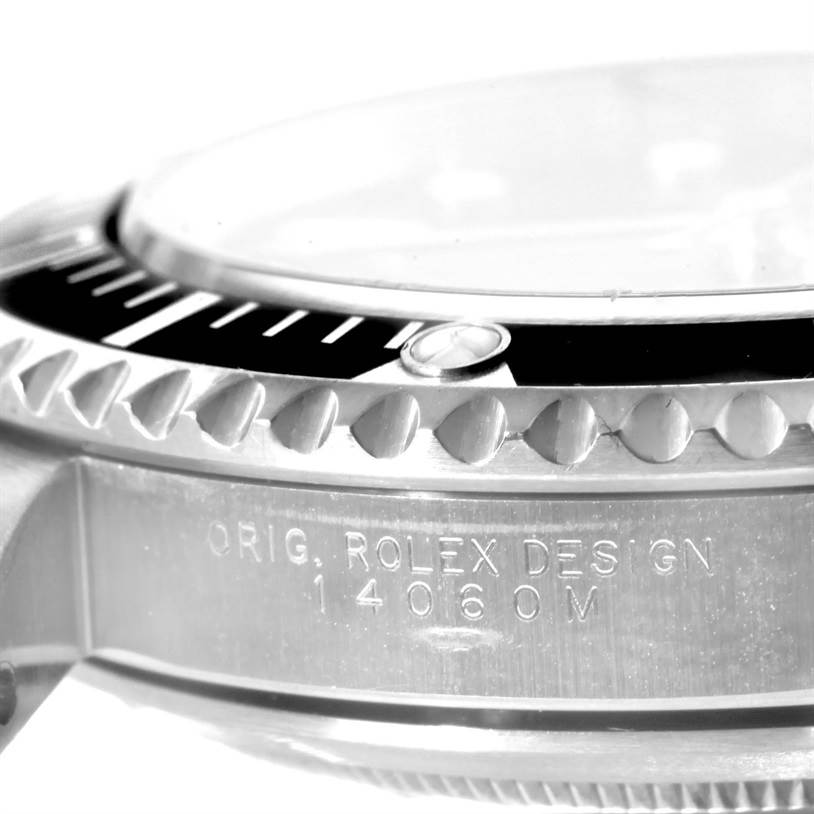 This image shows a side view of the Rolex Submariner 14060 Men
s Stainless Steel Black Dial 14060 Men
s Stainless Steel Black Dial, highlighting the bezel and engraved case with the model number 14060M.