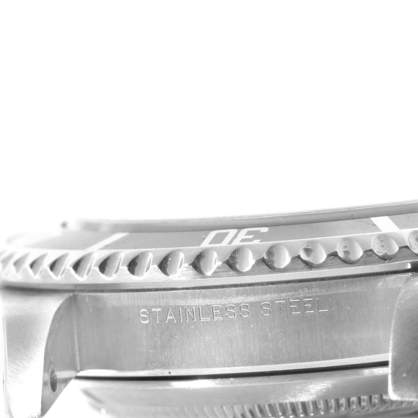 This close-up image of a Rolex Submariner 14060 Men
s Stainless Steel Black Dial 14060 Men
s Stainless Steel Black Dial watch shows the stainless steel case and bezel with partial numbering.