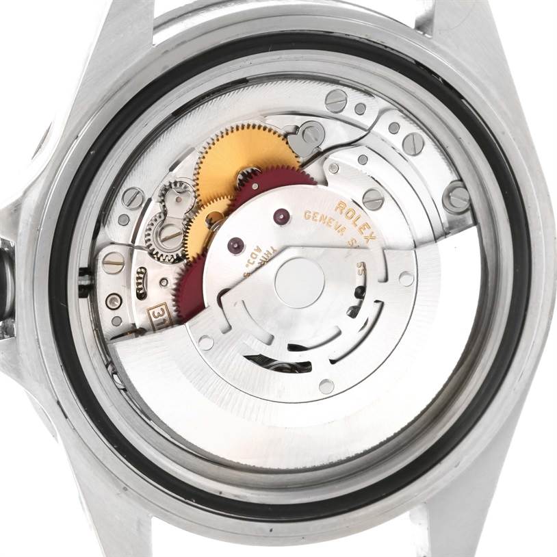 The image shows the internal mechanism of a Rolex Submariner 14060 Men
s Stainless Steel Black Dial 14060 Men
s Stainless Steel Black Dial watch from a back angle, including gears and Rolex engraving.