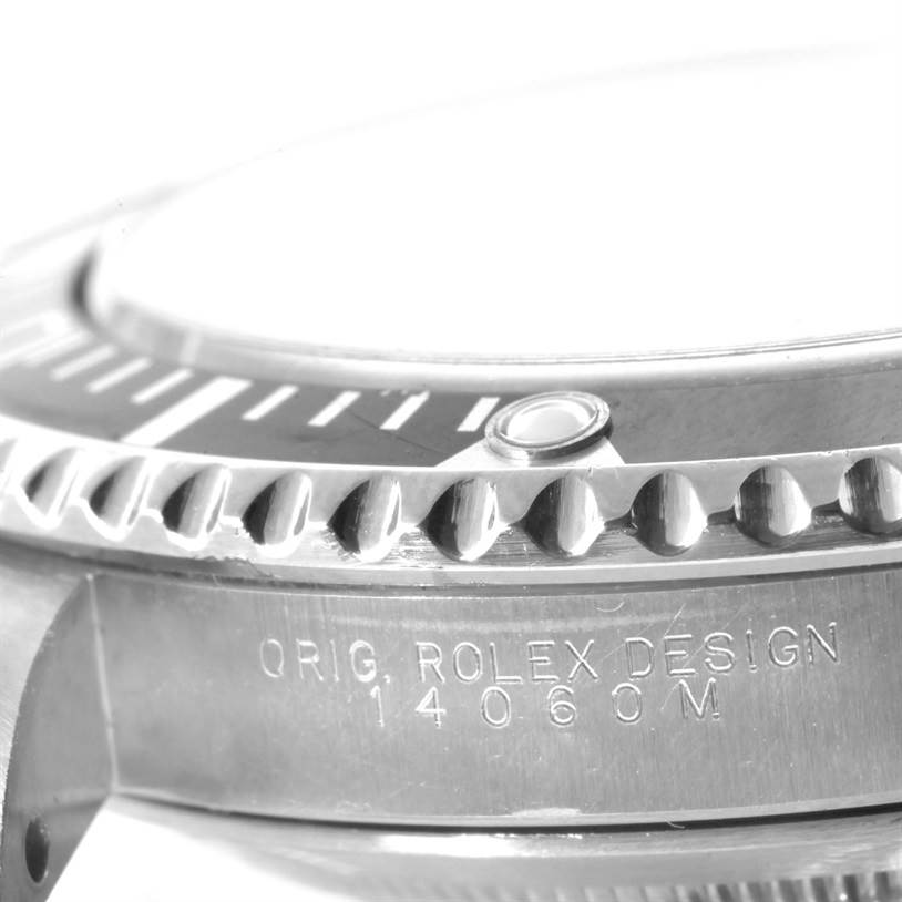 The image shows a close-up of the side and bezel of a Rolex Submariner 14060 Men
s Stainless Steel Black Dial 14060 Men
s Stainless Steel Black Dial, featuring the model number and "Orig. Rolex Design" engraving.