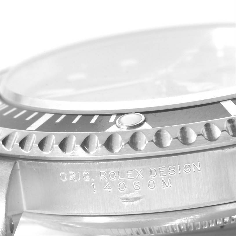 The image shows a close-up, side angle of the bezel and case, including model number engraving, of the Rolex Submariner 14060 Men
s Stainless Steel Black Dial 14060 Men
s Stainless Steel Black Dial watch.