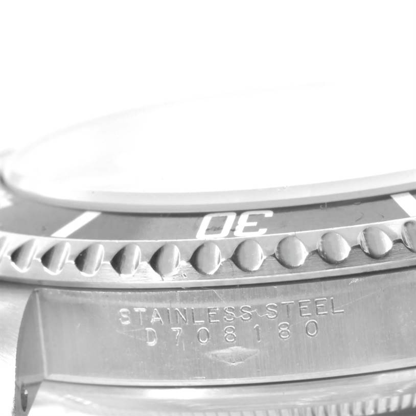 This image shows a close-up of the bezel and stainless steel caseback of a Rolex Submariner 14060 Men
s Stainless Steel Black Dial 14060 Men
s Stainless Steel Black Dial watch.