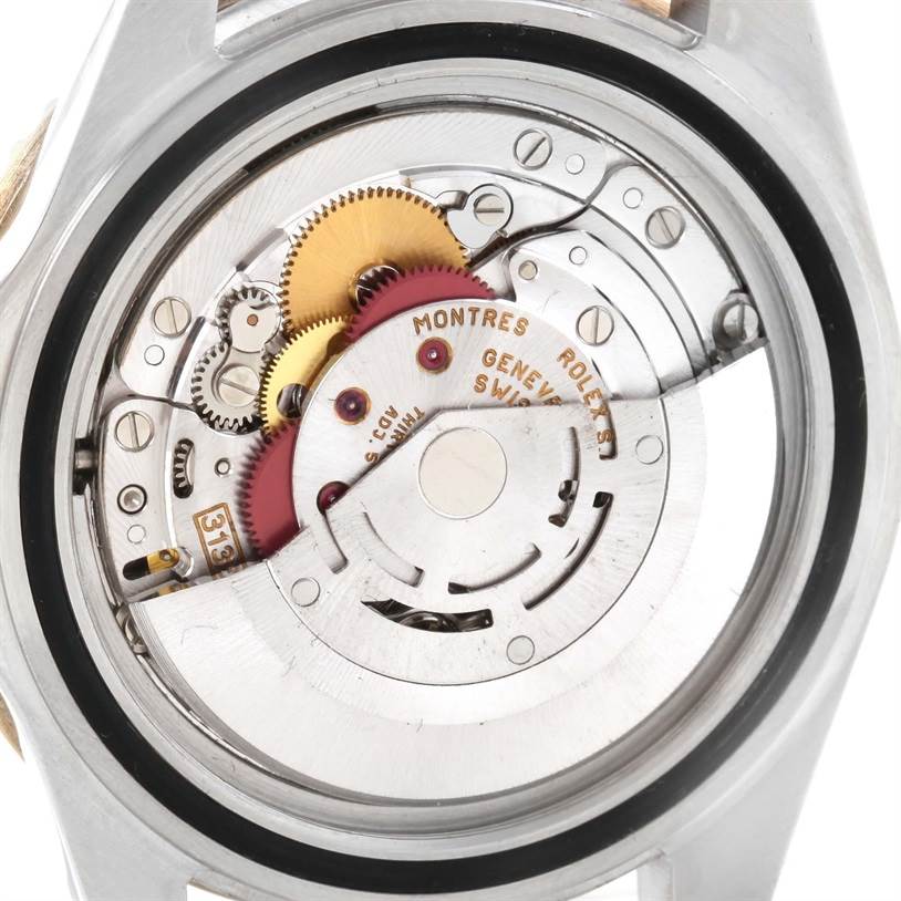 The image shows the internal mechanism and parts of a Rolex Submariner 16613 Men's Steel and Gold (two tone) Black Dial 16613 Men's Steel and Gold (two tone) Black Dial watch from a back angle.