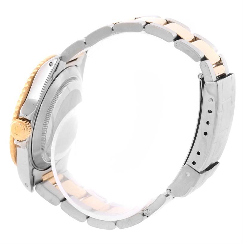 This image shows a side and partial rear view of the Rolex Submariner 16613 Men's Steel and Gold (two tone) Black Dial 16613 Men's Steel and Gold (two tone) Black Dial, highlighting the crown, case, and two-tone bracelet.