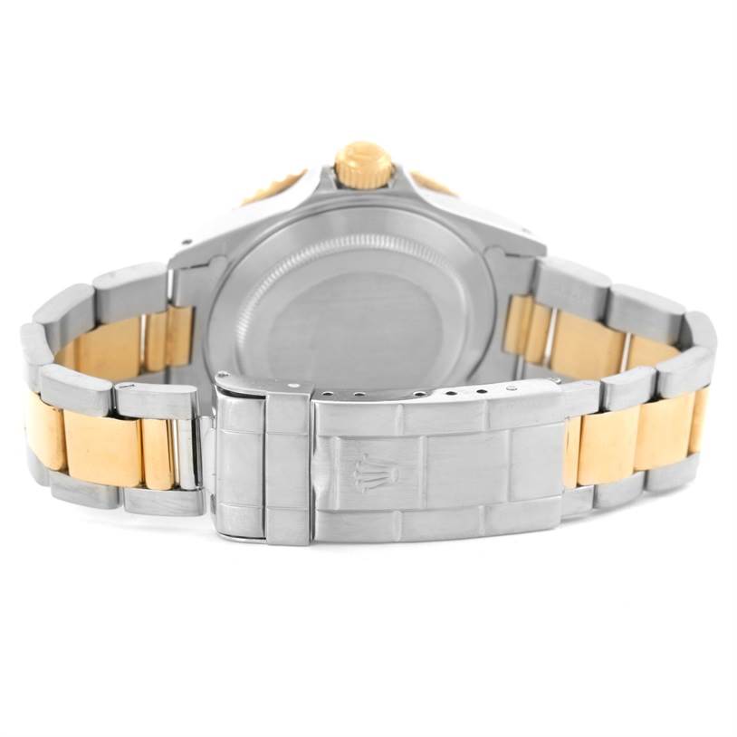 The image shows the back and clasp of a Rolex Submariner 16613 Men's Steel and Gold (two tone) Black Dial 16613 Men's Steel and Gold (two tone) Black Dial watch, highlighting the two-tone metal bracelet.