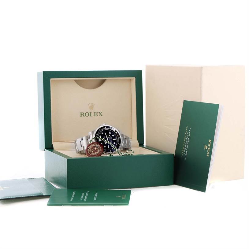 The image shows a Rolex Submariner 116610LN Men
s Stainless Steel Black Dial 116610LN Men
s Stainless Steel Black Dial watch displayed inside its open green box, along with its accompanying manuals and tags.