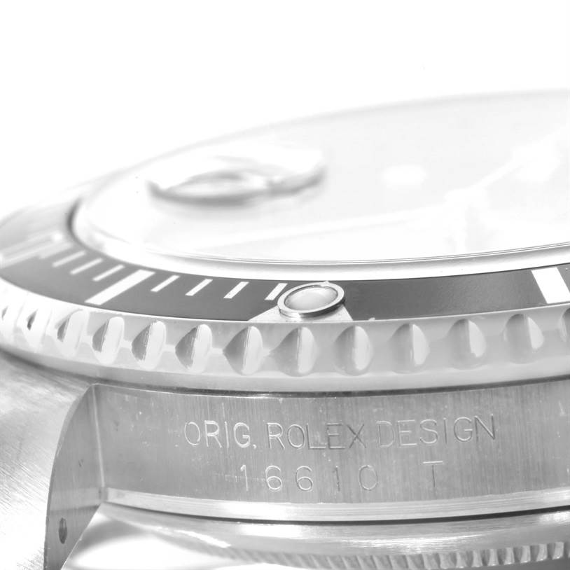 The image shows a close-up side angle of the bezel and part of the case of a Rolex Submariner 16610 Men
s Stainless Steel Black Dial 16610 Men
s Stainless Steel Black Dial watch, including model engraving.