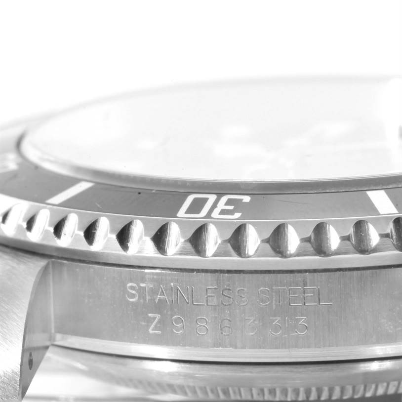 This image shows a side angle of the bezel and case of a Rolex Submariner 16610 Men
s Stainless Steel Black Dial 16610 Men
s Stainless Steel Black Dial watch, highlighting the stainless steel material and serial number.