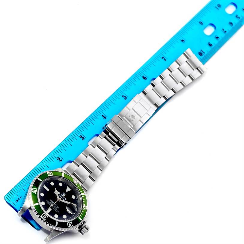 The Rolex Submariner 16610LV Men
s Stainless Steel Black Dial 16610LV Men
s Stainless Steel Black Dial watch is shown from a top-down angle, alongside a ruler for size reference.