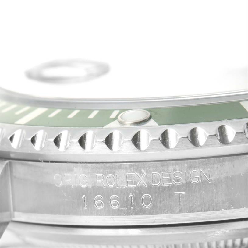 The image shows a close-up of the Rolex Submariner 16610LV Men
s Stainless Steel Black Dial 16610LV Men
s Stainless Steel Black Dial
s bezel and part of the case with engraved model details.