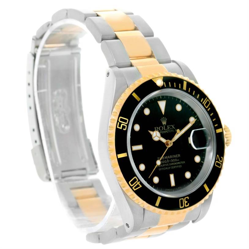 The Rolex Submariner 16613 Men's Steel and Gold (two tone) Black Dial 16613 Men's Steel and Gold (two tone) Black Dial watch is shown at a three-quarter angle, displaying its black dial, gold accents, and two-tone metal bracelet.