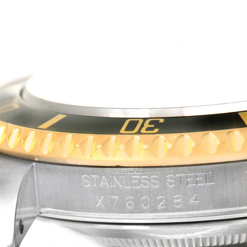 This image shows a close-up of the bezel and serial number engraving on a Rolex Submariner 16613 Men's Steel and Gold (two tone) Black Dial 16613 Men's Steel and Gold (two tone) Black Dial watch.