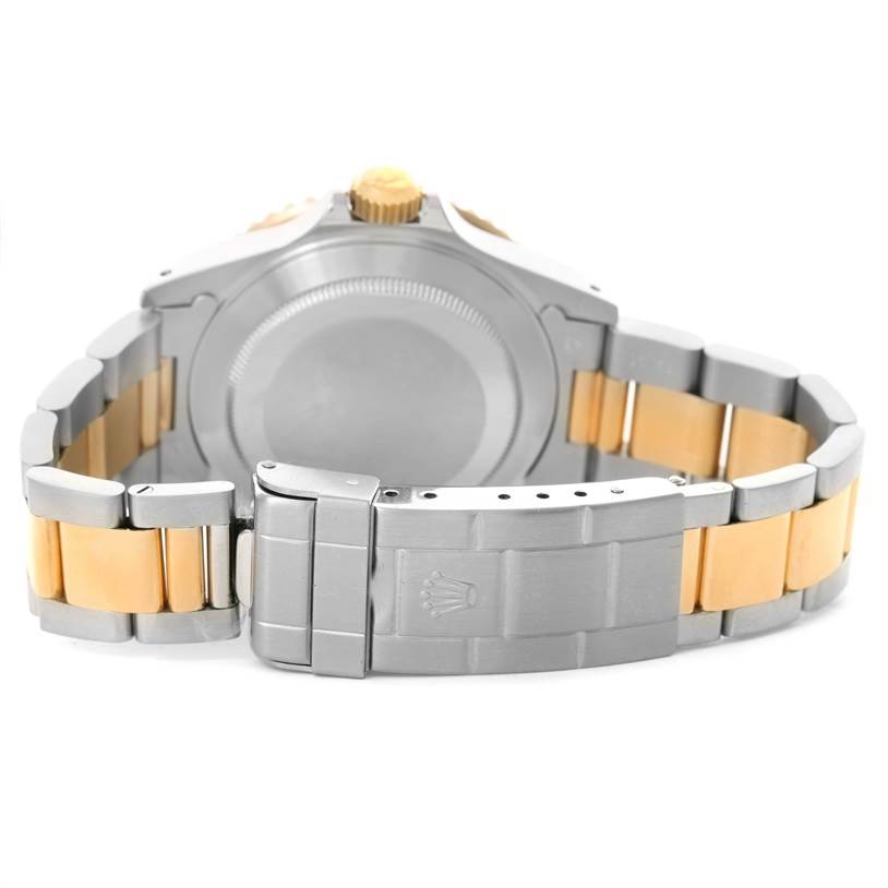 The image shows the back and bracelet clasp of a Rolex Submariner 16613 Men's Steel and Gold (two tone) Black Dial 16613 Men's Steel and Gold (two tone) Black Dial watch, displaying its two-tone metal design.
